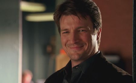 Castle actor Nathan Fillion in a black suit caught at the camera.